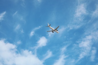Photo of Modern airplane flying in blue sky low angle view