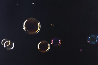 Beautiful transparent soap bubbles on dark background