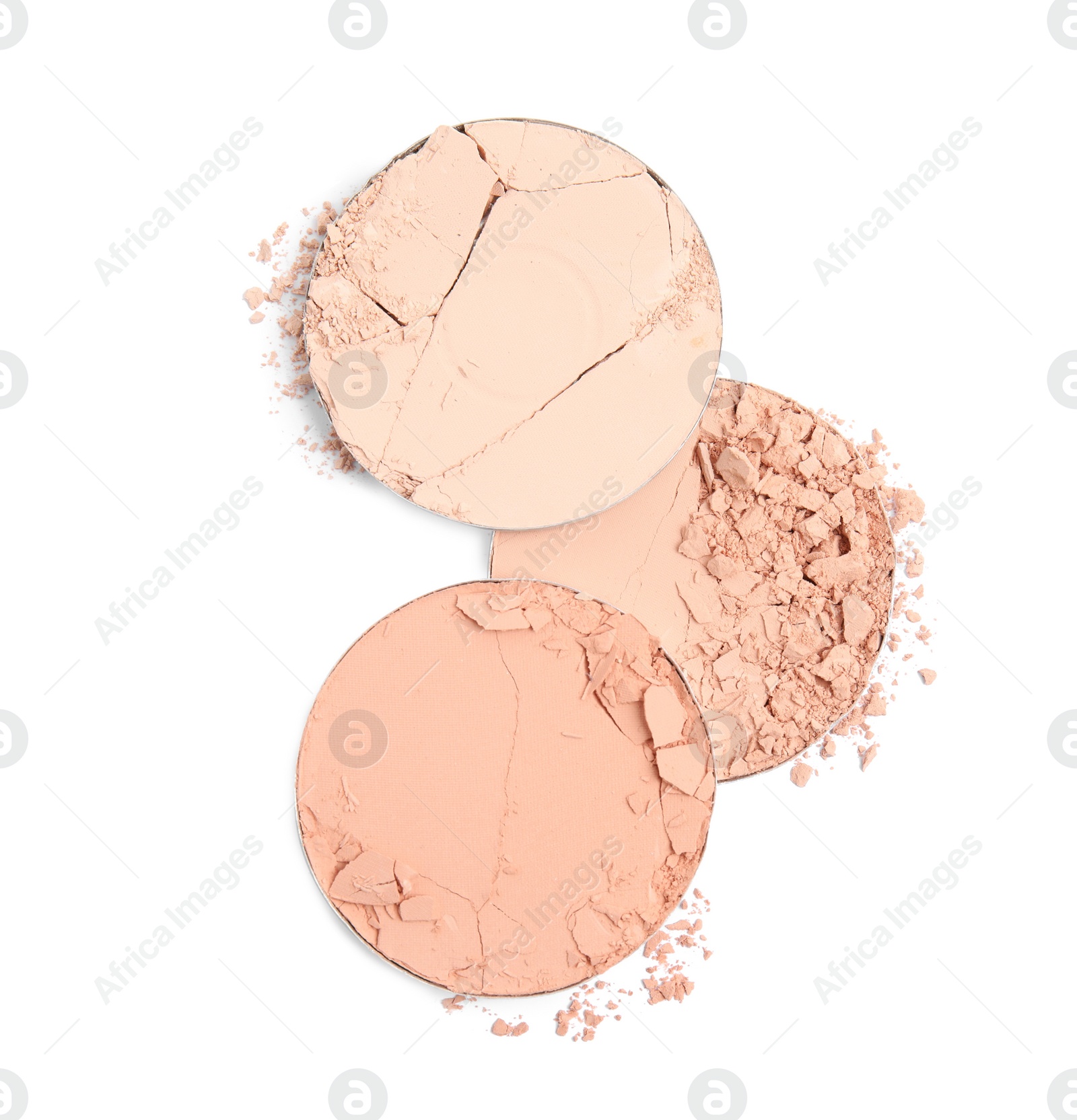 Photo of Different broken face powders on white background, top view