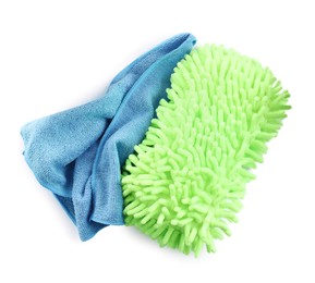 Photo of Cloth and car wash mitt on white background, top view