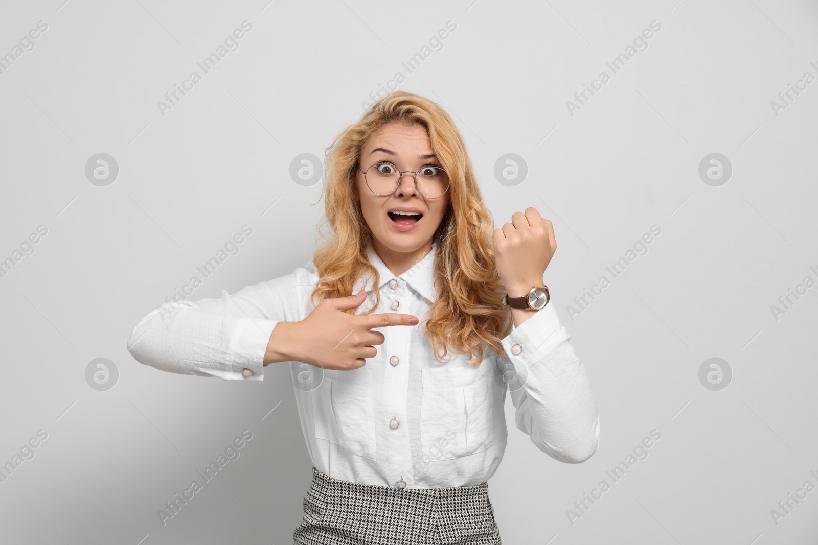 Photo of Emotional businesswoman in turmoil over being late on white background