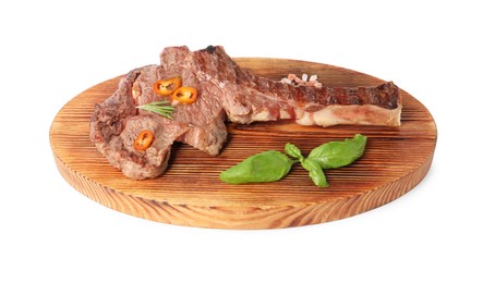 Photo of Wooden board with delicious fried beef meat, chili pepper and basil isolated on white