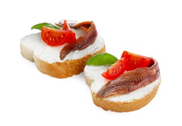 Photo of Delicious sandwiches with cream cheese, anchovies, tomatoes and basil on white background