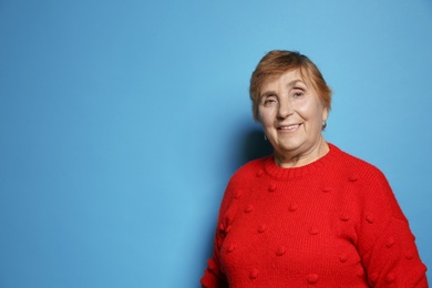 Photo of Portrait of elderly woman on color background. Space for text
