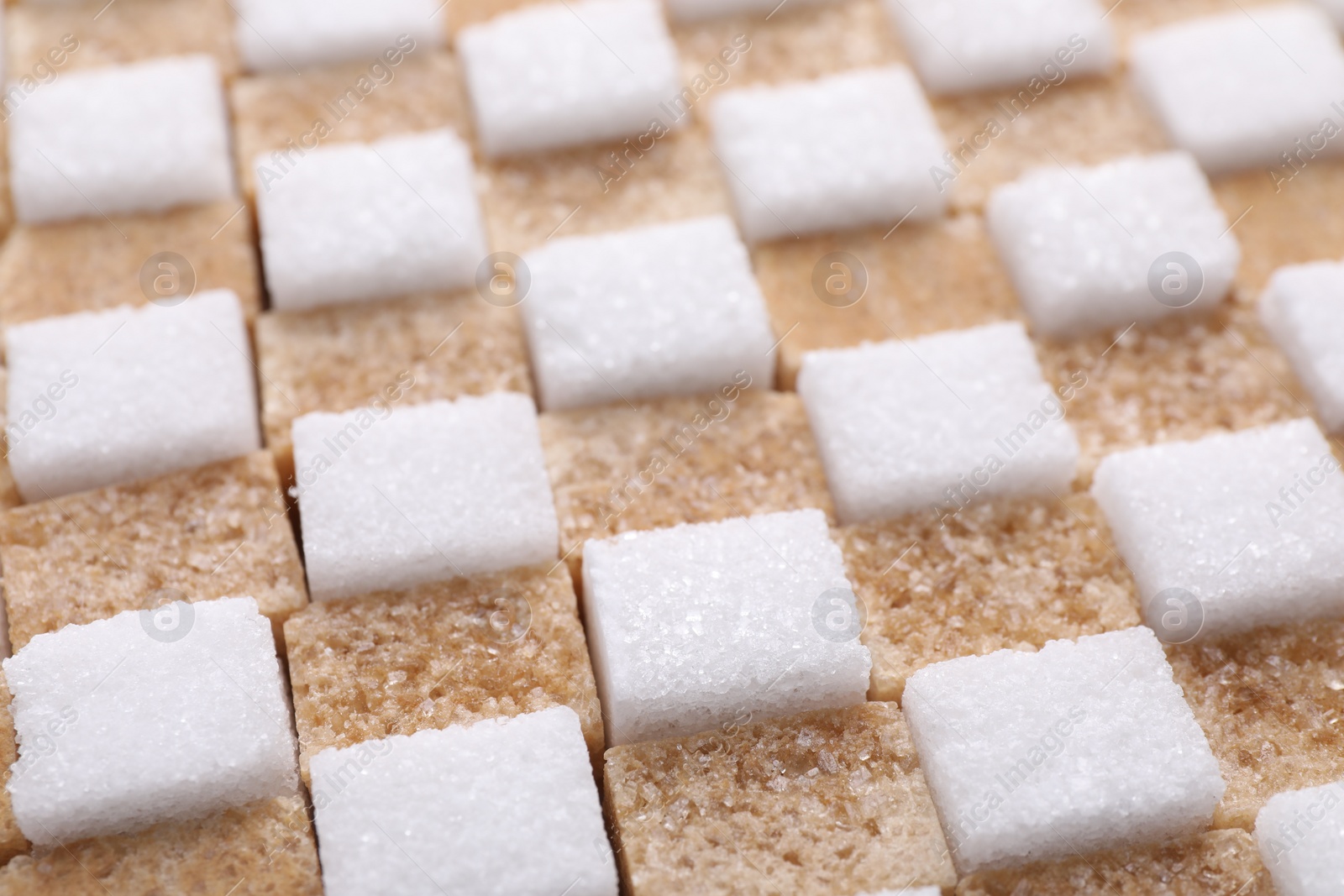 Photo of White and brown sugar cubes as background, closeup