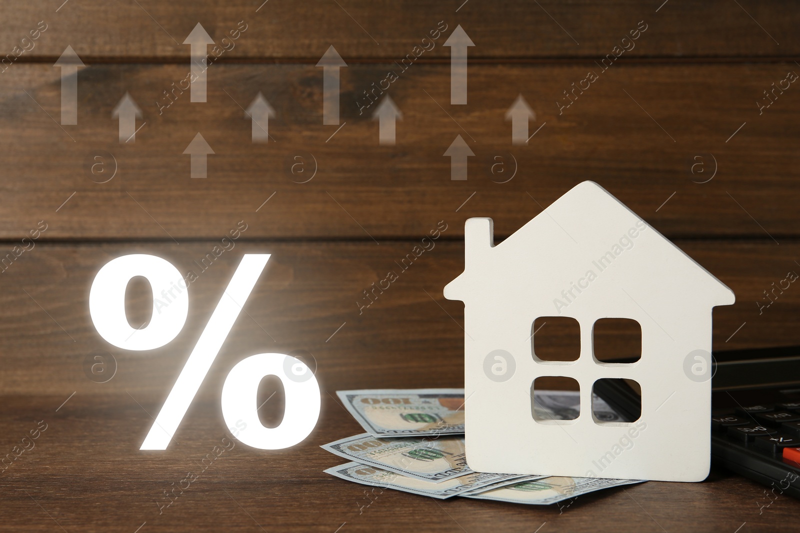 Image of Mortgage. House model, money, arrows and percent sign on wooden background