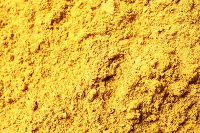 Dry curry powder as background, top view