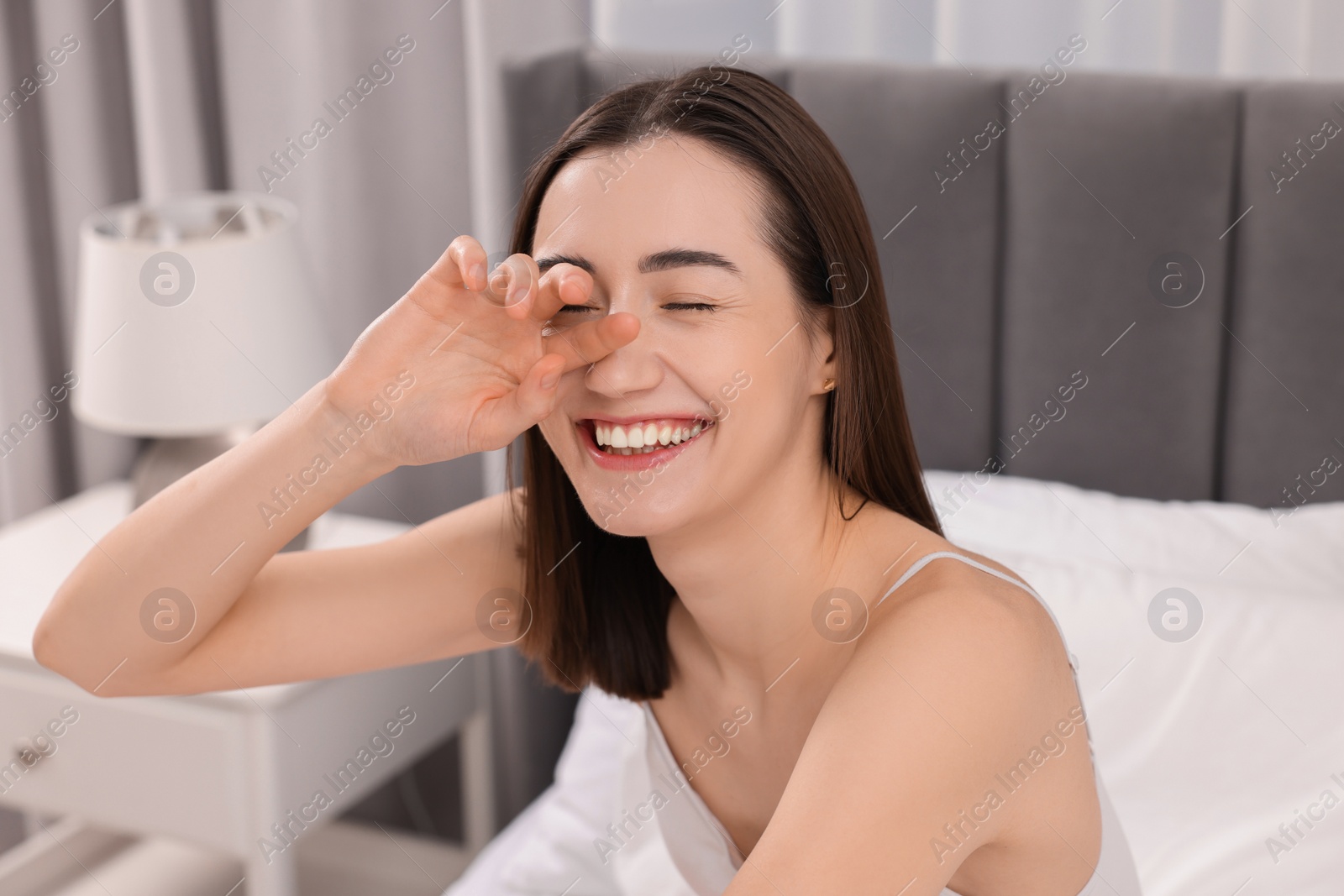 Photo of Portrait of beautiful woman laughing in bedroom