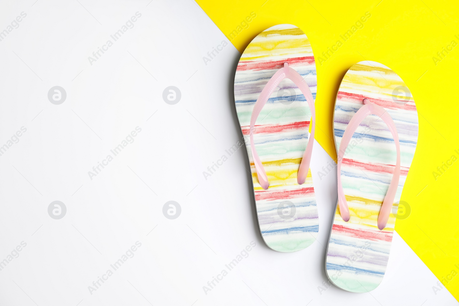 Photo of Flat lay composition with flip flops on color background, space for text. Beach objects