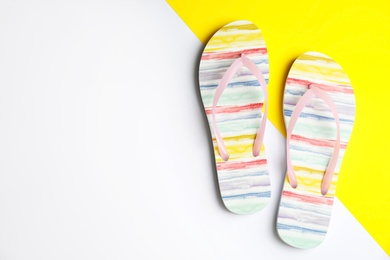 Flat lay composition with flip flops on color background, space for text. Beach objects