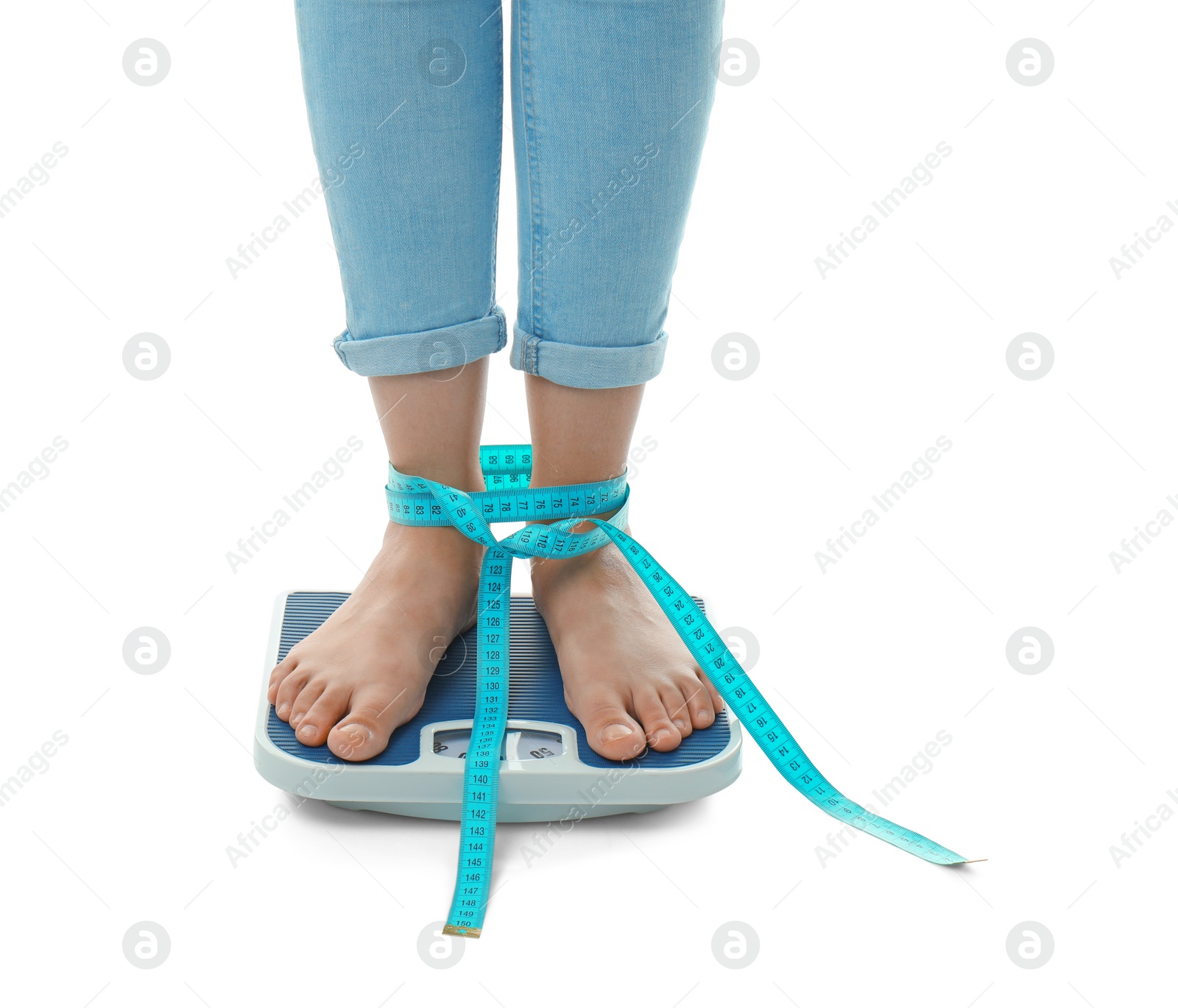 Photo of Woman with tape measuring her weight using scales on white background. Healthy diet