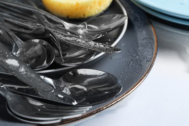 Plates with silverware in foam and sponge, closeup