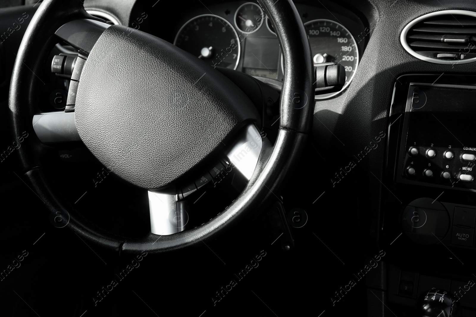 Photo of Black steering wheel and dashboard in car