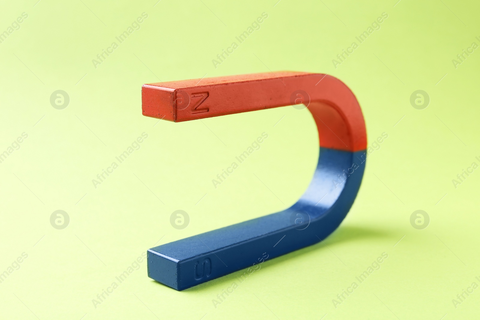 Photo of Red and blue horseshoe magnet on color background