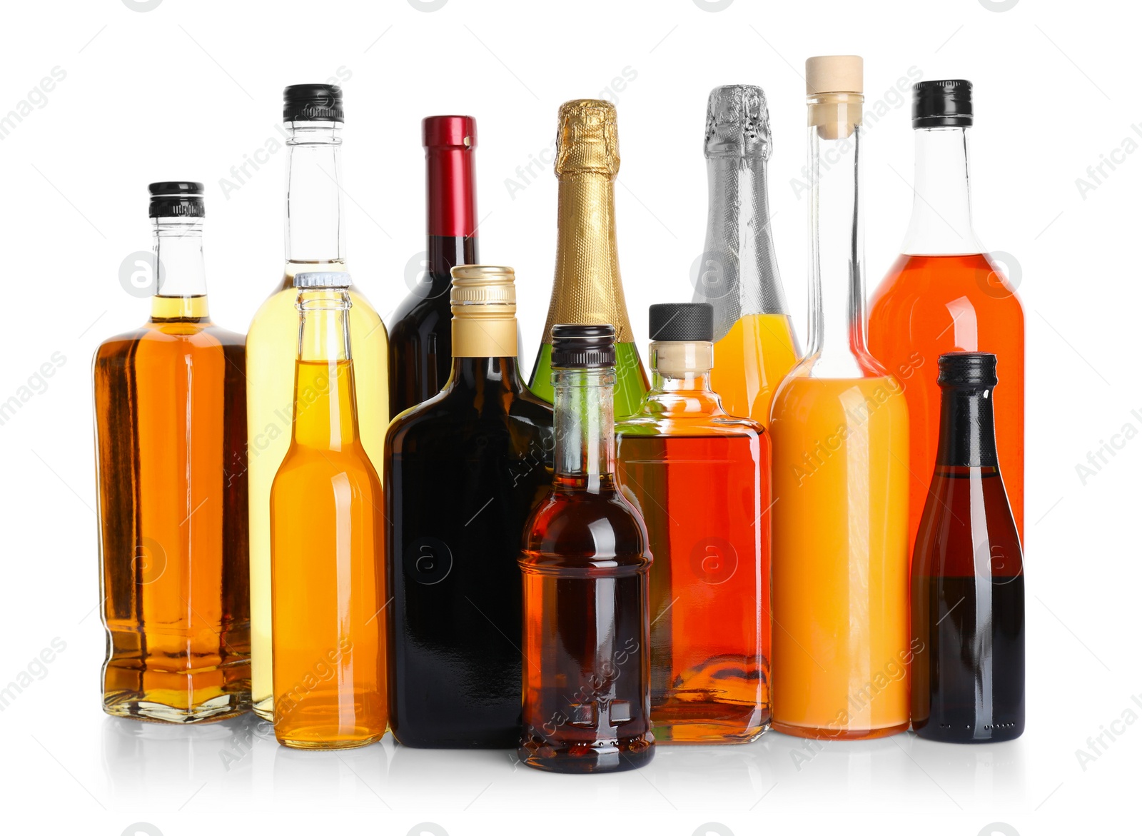 Photo of Bottles of different alcoholic drinks isolated on white