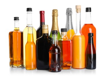 Bottles of different alcoholic drinks isolated on white