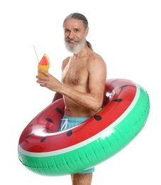 Shirtless man with inflatable ring and glass of cocktail on white background