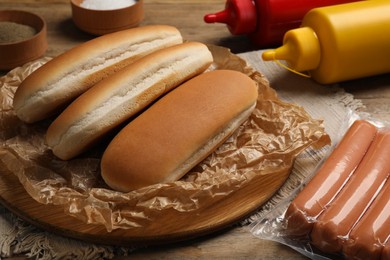 Different tasty ingredients for hot dog on table