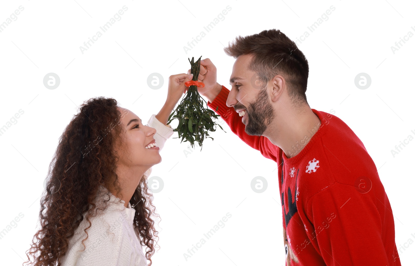 Photo of Lovely couple under mistletoe bunch on white background