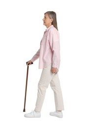 Senior woman with walking cane on white background