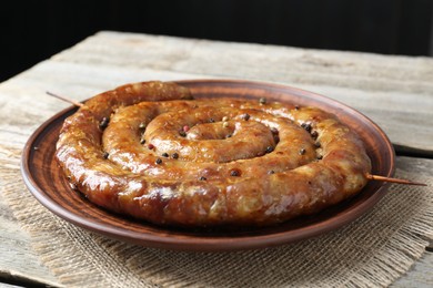 Plate with tasty homemade sausages on table, closeup