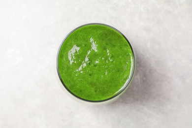 Photo of Delicious fresh green juice on grey table, top view