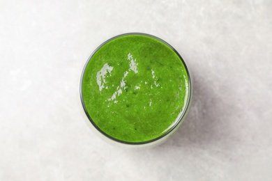 Delicious fresh green juice on grey table, top view