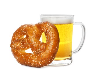 Photo of Tasty freshly baked pretzel and mug of beer on white background