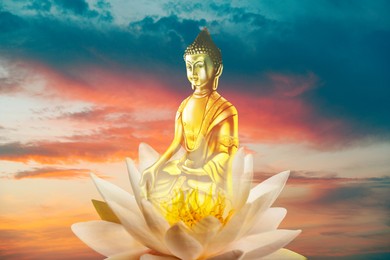 Golden Buddha sculpture in lotus and beautfiful sky at sunset on background