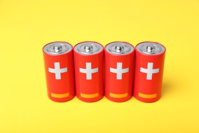 Photo of New red C batteries on yellow background