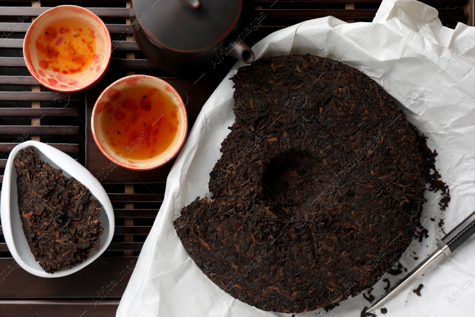 Photo of Flat lay composition with pu-erh tea on wooden tray