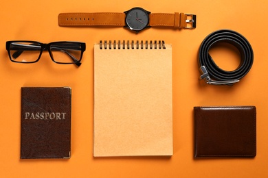 Photo of Flat lay composition with male accessories, passport and notebook on colorful background. Space for text