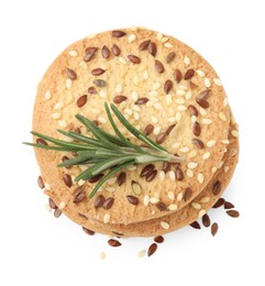 Photo of Stack of round cereal crackers with flax, sunflower, sesame seeds and rosemary isolated on white, top view