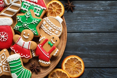 Flat lay composition with tasty homemade Christmas cookies on dark blue wooden table