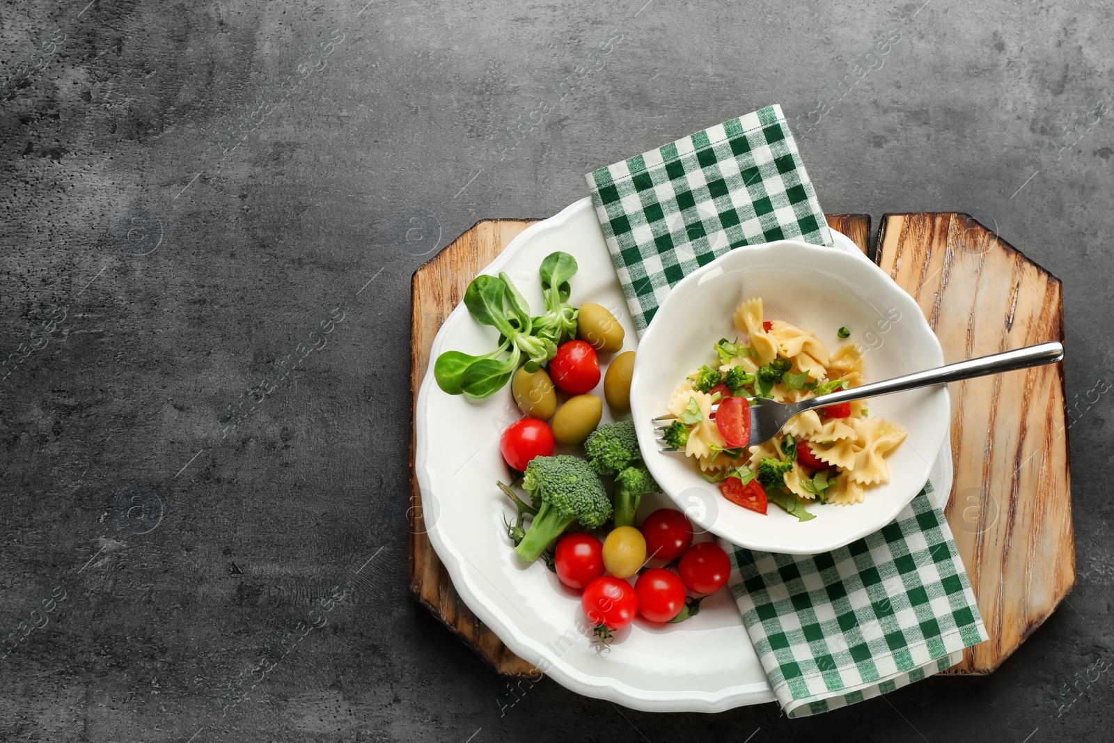 Photo of Tasty pasta salad with vegetables on table