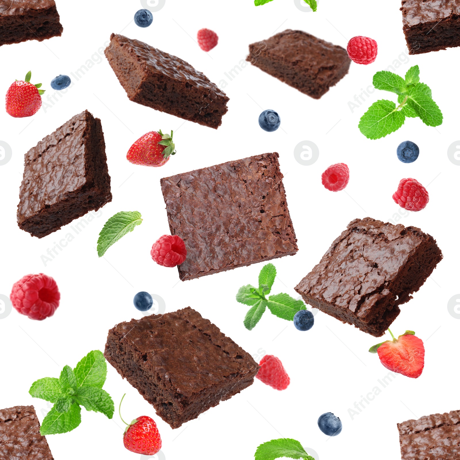 Image of Slices of delicious chocolate brownie with fresh berries and mint flying on white background