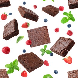 Image of Slices of delicious chocolate brownie with fresh berries and mint flying on white background