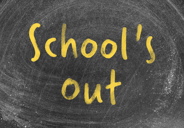 Image of Text SCHOOL'S OUT written on dirty blackboard
