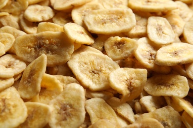 Sweet banana slices as background. Dried fruit as healthy snack