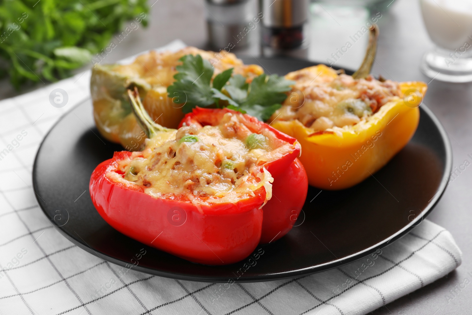 Photo of Tasty stuffed bell peppers served on grey table