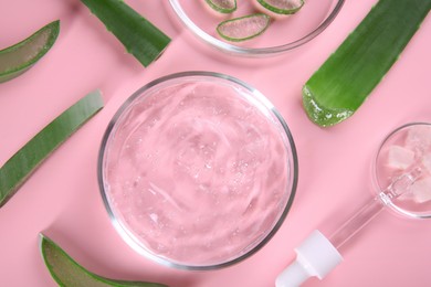 Photo of Flat lay composition with aloe vera leaves and cosmetic gel on pink background