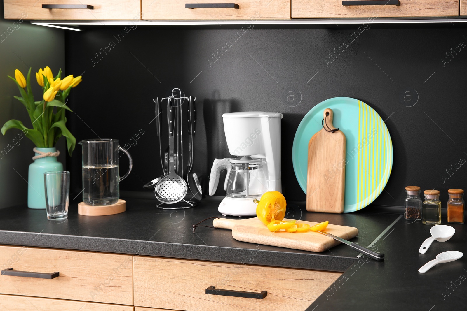 Photo of Stylish kitchen counter with set of houseware