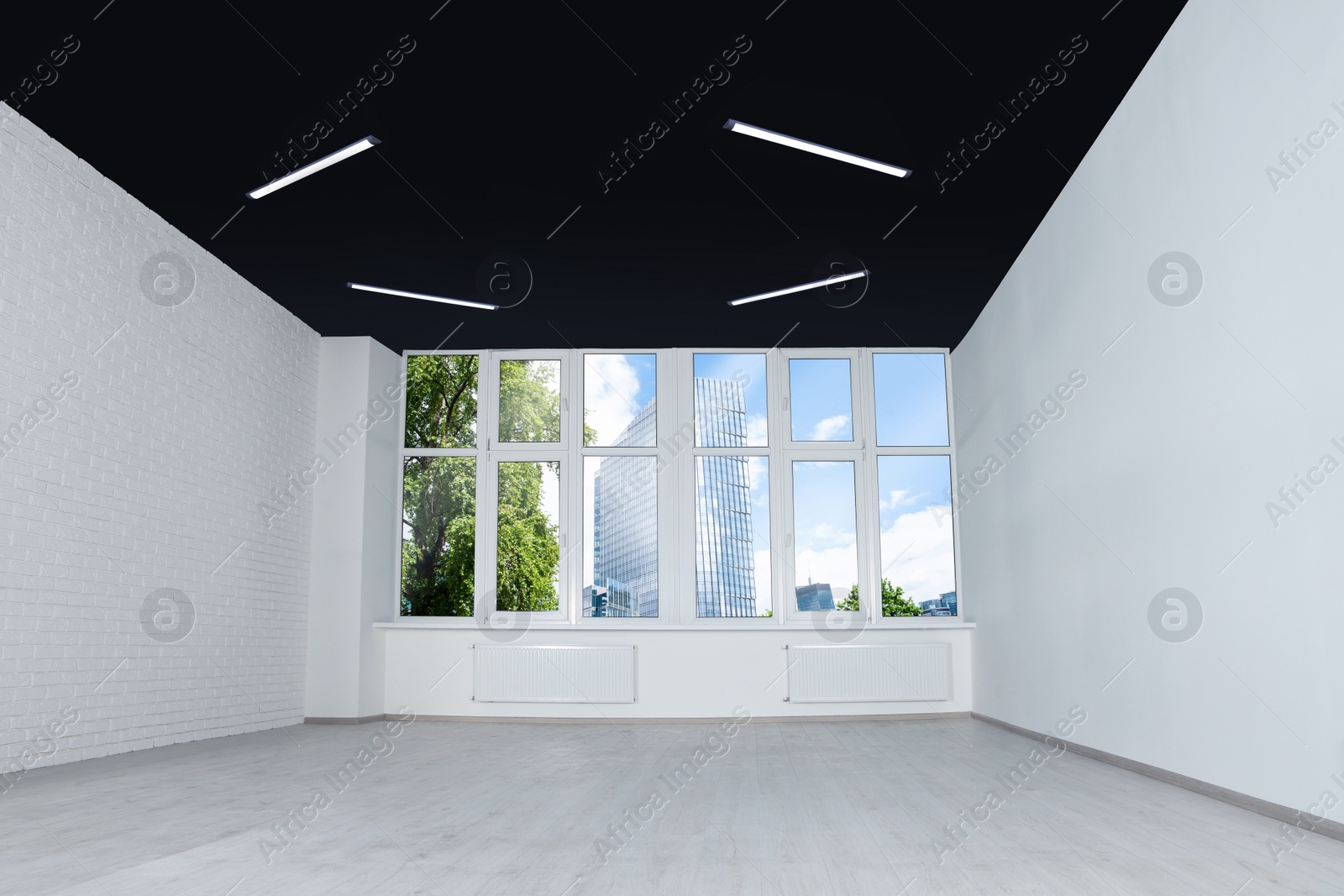 Photo of Empty office room with black ceiling and clean windows. Interior design