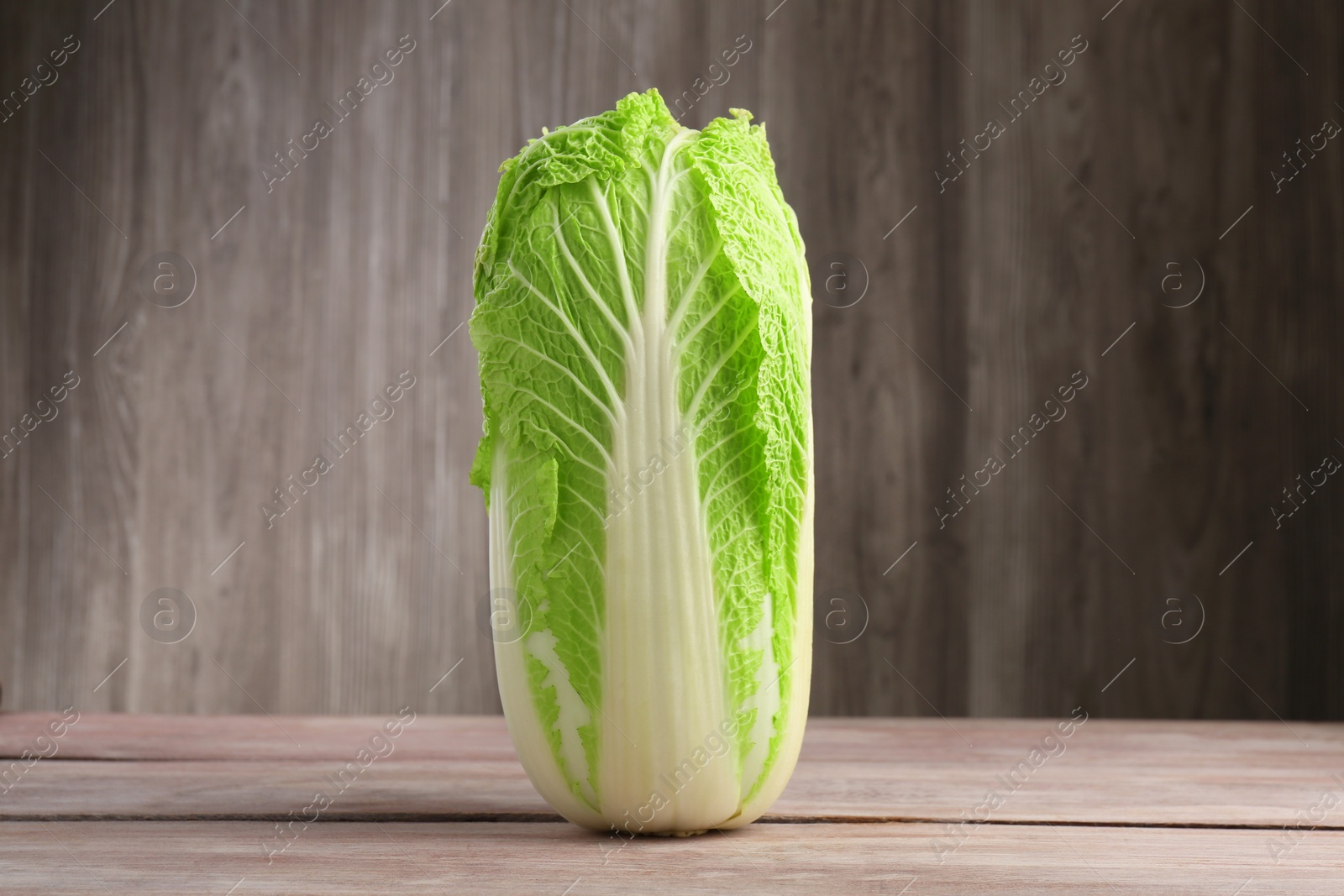 Photo of Fresh ripe Chinese cabbage on wooden table