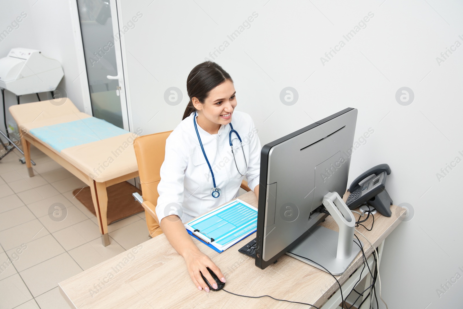 Photo of Portrait of young gynecologist at table in hospital