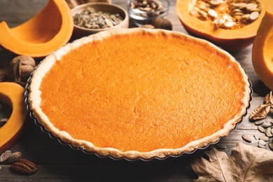 Photo of Delicious homemade pumpkin pie on wooden table