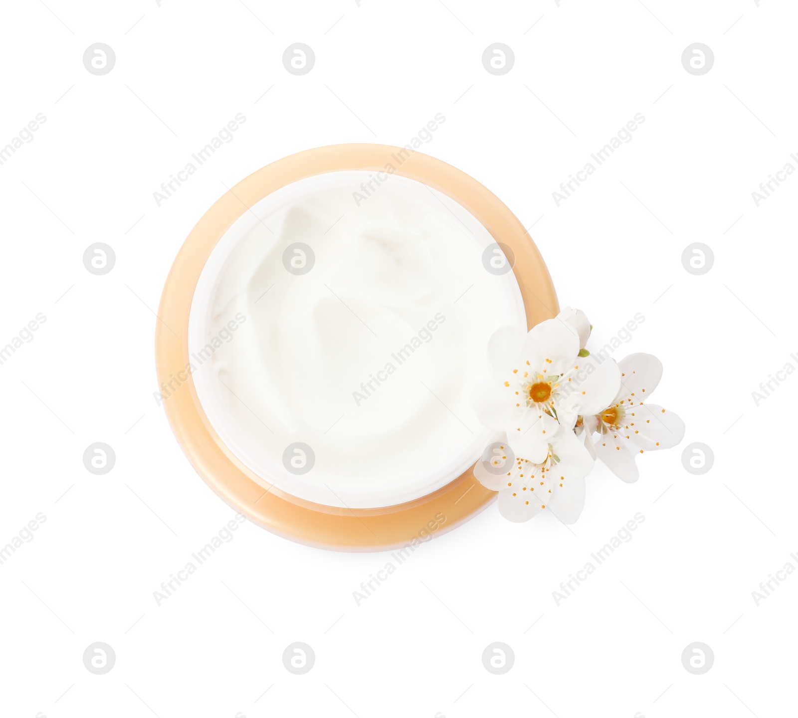 Photo of Face cream in jar and flowers on white background, top view