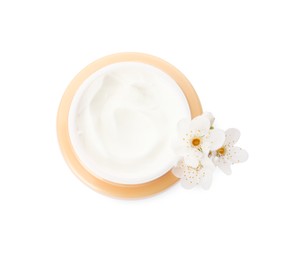Photo of Face cream in jar and flowers on white background, top view