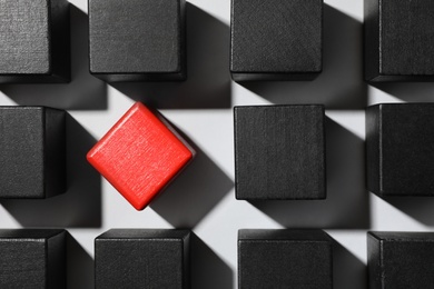 Photo of Red cube among others on white background, flat lay