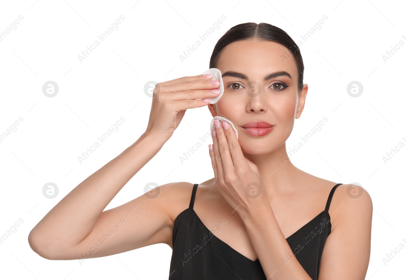 Photo of Beautiful woman removing makeup with cotton pads on white background